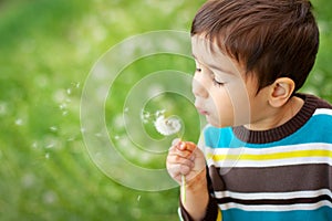 Kid blowing dandelion