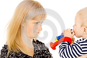 Kid blowing on mother in football beep photo