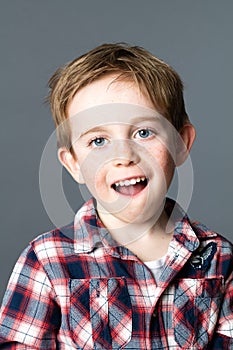 Kid with blue eyes playing with mouth for fun wellbeing