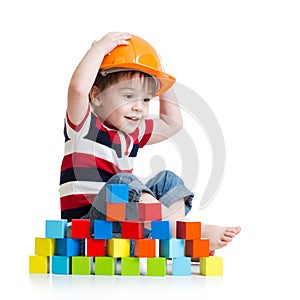 Kid boy as a construction worker in protective helmet