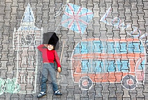 Kid boy in british soldier uniform with London chalks picture