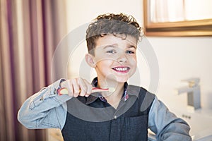 Kid boy brushing teeth