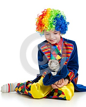 Kid boy clown with kitten inside hat over the white background