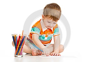 Kid boy drawing with colour pencils