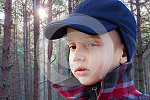 Kid boy forest fashion portrait checked coat cap