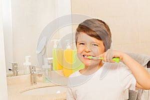 Kid boy happy to brush teeth in the morning