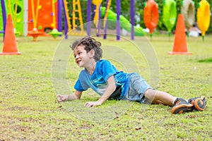 Kid boy having fun to play children`s playground area at school,