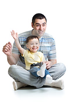 Kid boy and his dad playing with a playstation together