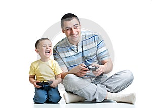 Kid boy and his dad playing with a playstation together photo