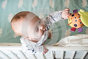 Kid boy infant standing in his bed