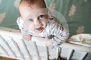 Kid boy infant standing in his bed