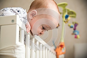 Kid boy infant standing in his bed