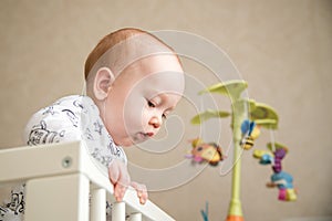 Kid boy infant standing in his bed