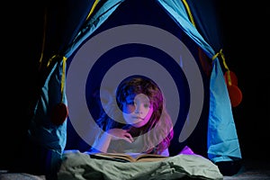 Kid boy in kids tent reading books. Towards knowledge. Boy with book read story, enjoy study and reading book. Book