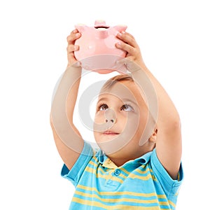 Kid, boy and piggy bank for change, money box and checking savings in studio by white background. Male person, child and