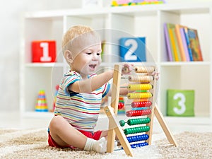 Kid boy playing with abacus