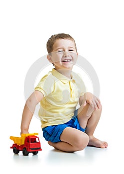 Kid boy playing with toy car