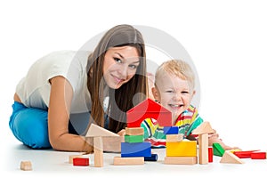 Kid boy playing toys together mother