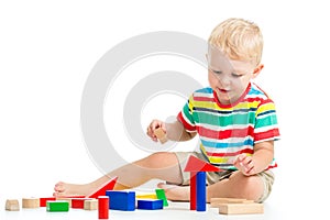 Kid boy playing wooden toys