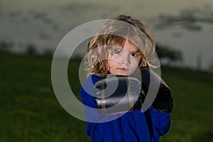 Kid boy practicing martial arts outdoor. Sport martial arts kids. Little boy wearing kimono doing karate in park. Child