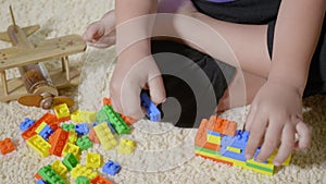 Kid boy preschool playing creative plastic toy blocks