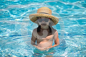 Kid boy swim in swimming pool. Summertime and swimming activities for children on the pool. Active kids healthy