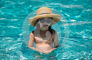 Kid boy swim in swimming pool. Summertime and swimming activities for children on the pool. Active kids healthy