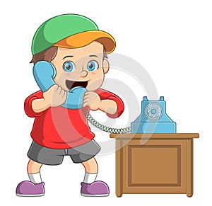 Kid boy talking on a retro wired telephone