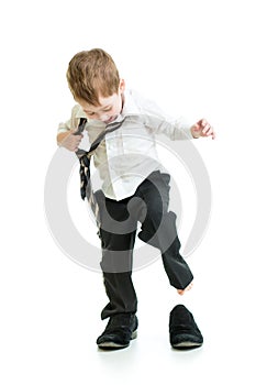 Kid boy trying on father shoes