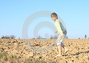 Kid - boy walking on field