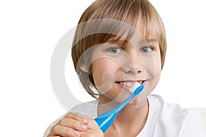 Kid brushing his teeth with toothbrush isolated on white backgroun