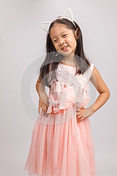 Kid with Cat Ear Headband in Pink Dress, Isolated on White