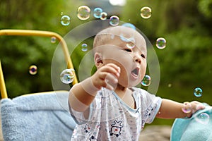 Kid catching soap bubbles