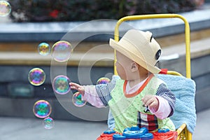 Kid catching soap bubbles