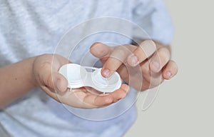 kid child little boy holding silicone contact lens
