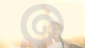 Kid children sisters play with a garden trolley car ride on wheelbarrow. little girl child in hat happy family