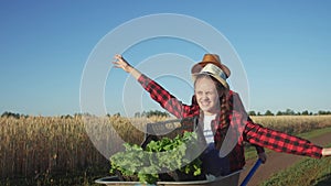 kid children sisters play with a garden trolley car ride on wheelbarrow. little girl child in hat happy family