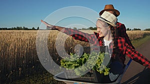 kid children sisters play with a garden trolley car ride on wheelbarrow. little girl child in hat happy family