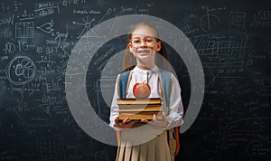 Kid in class on background of blackboard