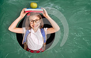 Kid in class on background of chalkboard