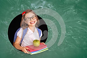 Kid in class on background of chalkboard