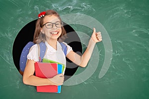 Kid in class on background of chalkboard