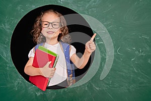 Kid in class on background of chalkboard