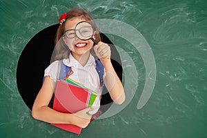 Kid in class on background of chalkboard