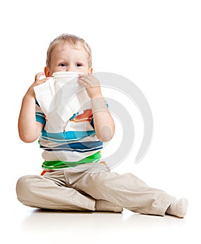 Kid cleaning nose with tissue