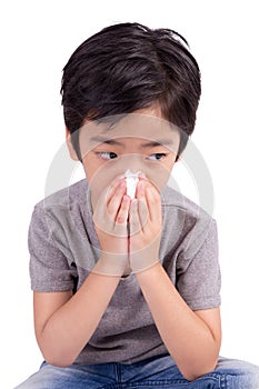 Kid cleaning nose with tissue