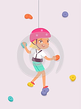 Kid climber climbing rock wall, fearless girl in safety helmet bouldering, hanging on rope