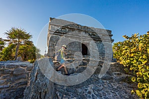 Kid climbing on the top of antique ruins