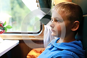 Kid in compartment of retro train carriage
