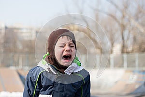 Kid crying very loud in a temper tantrum photo